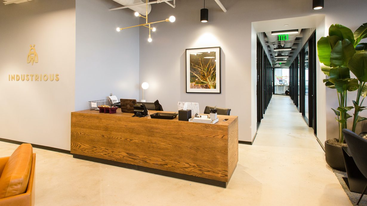 The warm and inviting reception area at Industrious Uptown.
