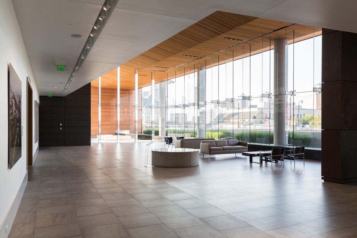 The building’s two-story lobby is warm, bright, and inviting.