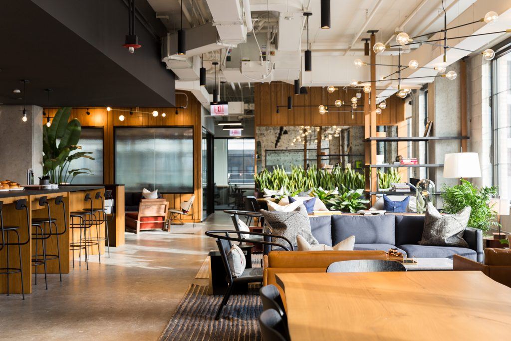 Sleek wood furnishings and plenty of greenery create an inviting atmosphere in Chicago’s Industrious Fulton Market.