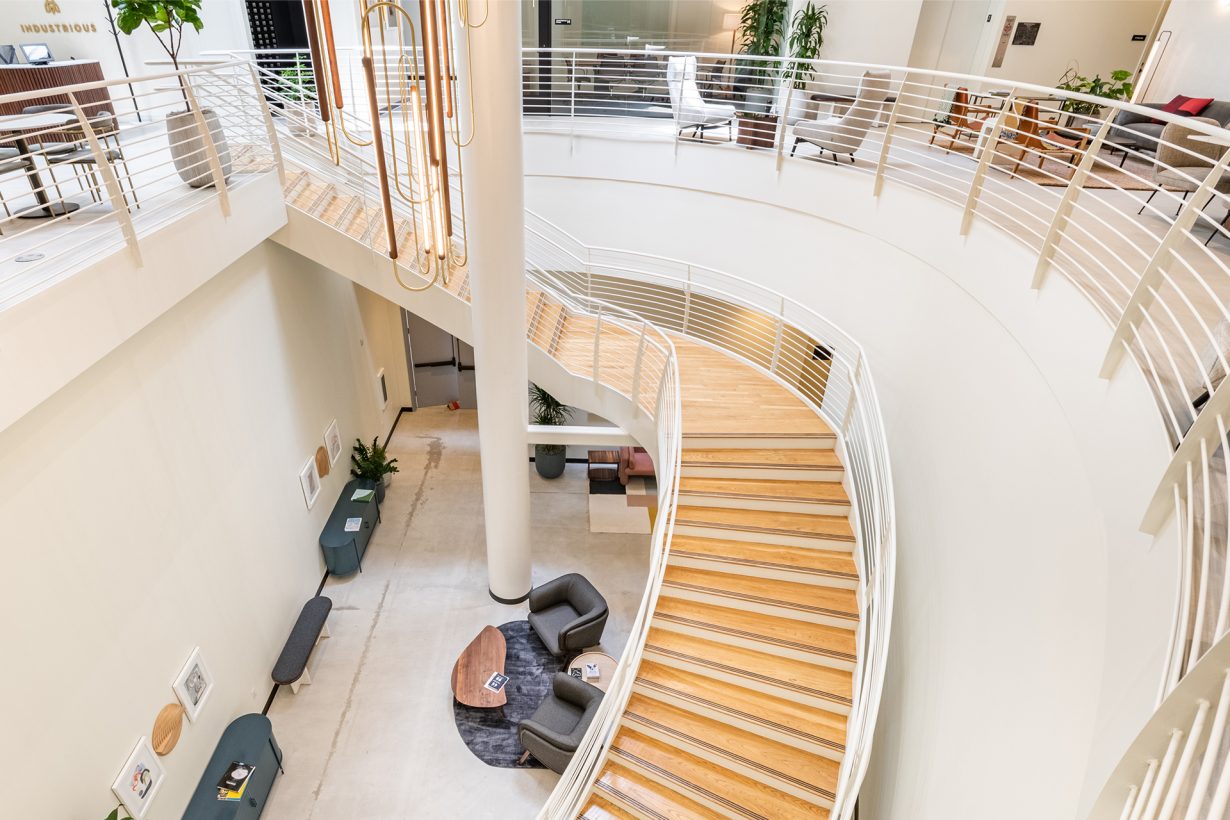 The grand staircase at this multi-story location sweeps past member lounge space and a gallery wall featuring local art.