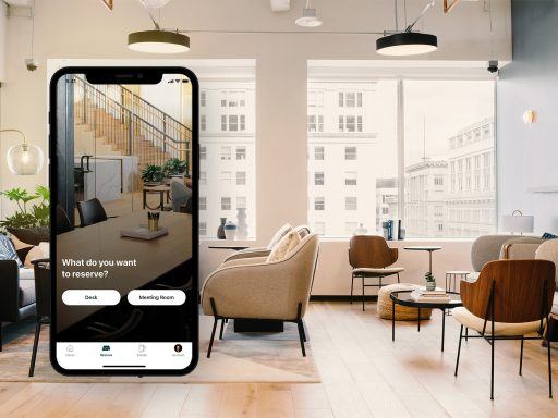 Header image showing the industrious mobile app screen, with options to book a meeting room or desk, juxtaposed with an industrious office space in the background.